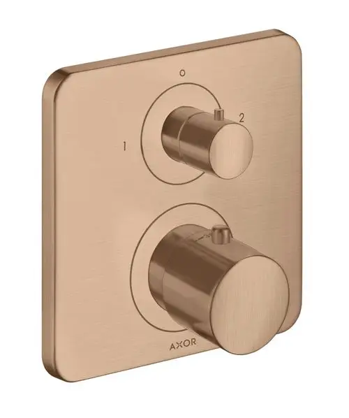 Thermostatunterputz von AXOR mit zwei Drehreglern auf einer rechteckigen Plattenoberfläche in Brushed Red Gold.